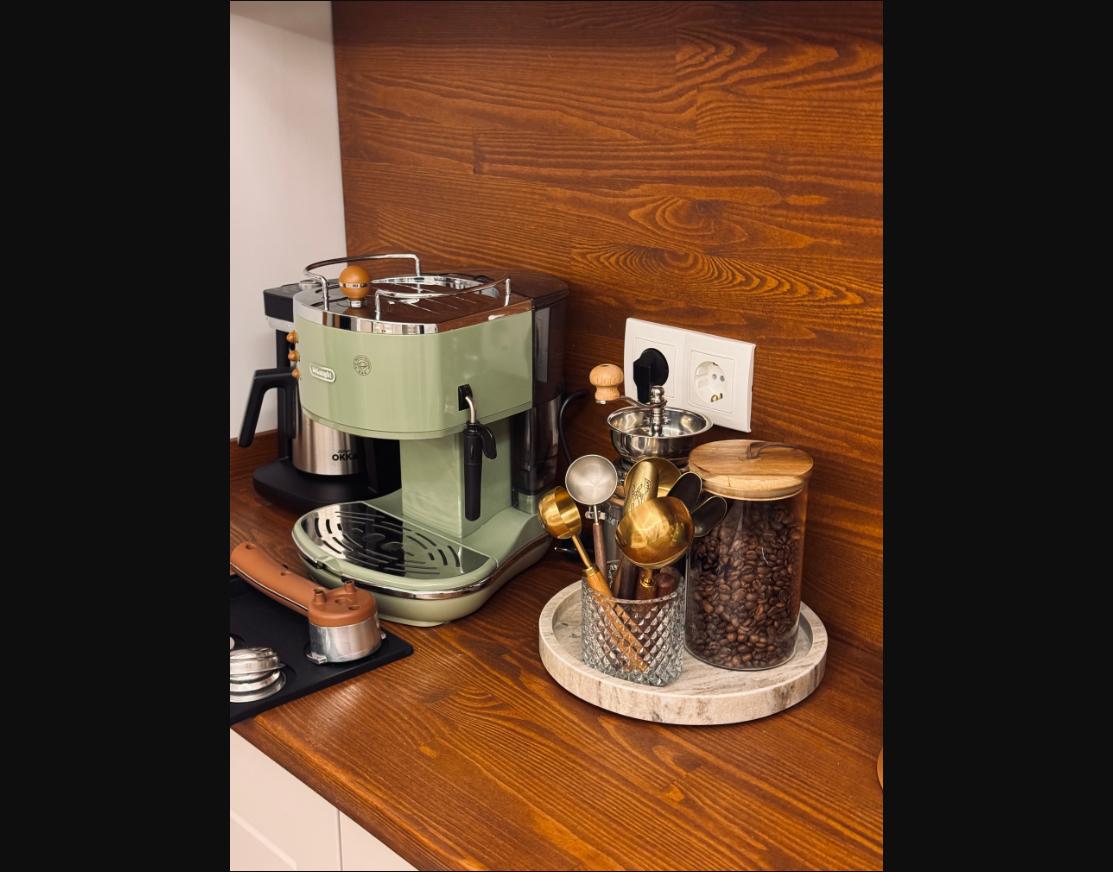 A dedicated coffee corner with an espresso machine and matching ceramics.