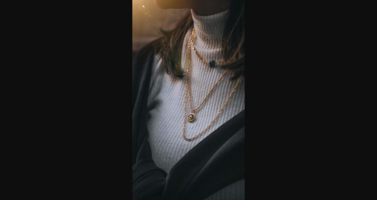 Styling accessories — belt, scarf, and jewelry — used to elevate a simple outfit.