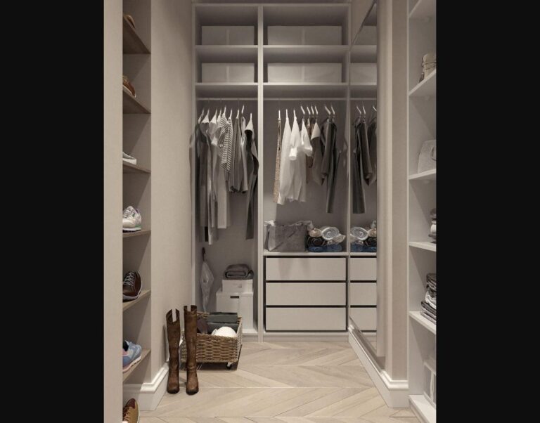 An organized small closet with uniform hangers and concealed storage.