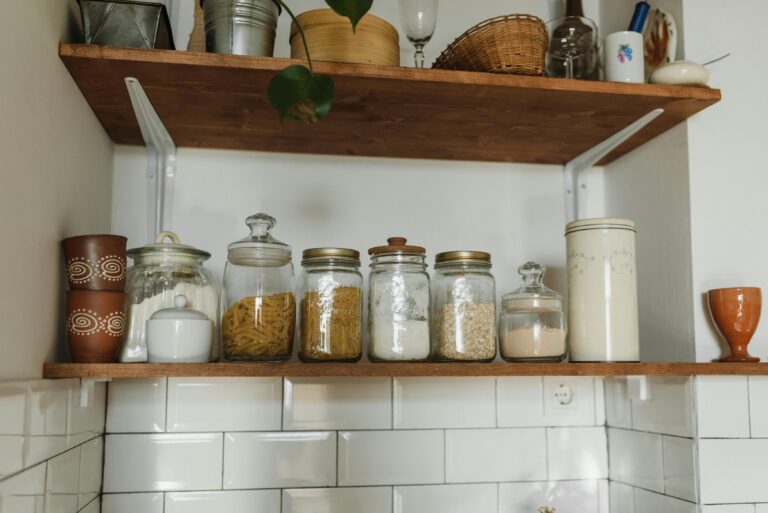minimalist micro pantry setup with glass bamboo jars and woven baskets