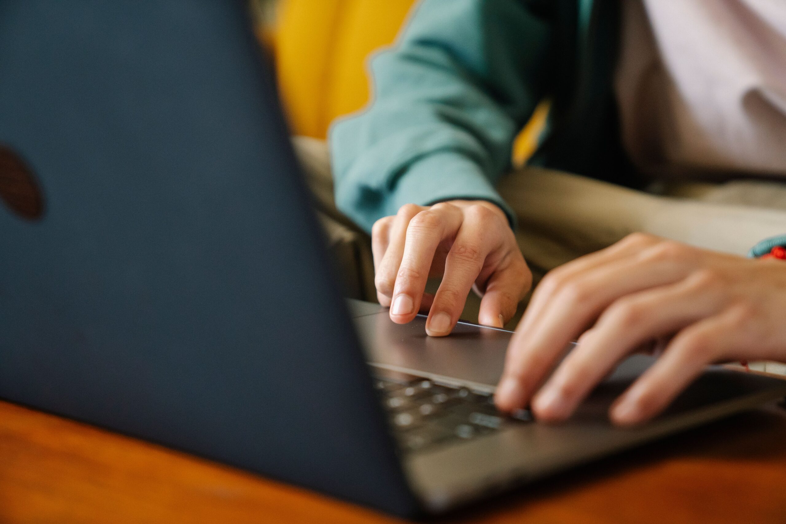 Person typing on a laptop, representing using an AI chatbot for free